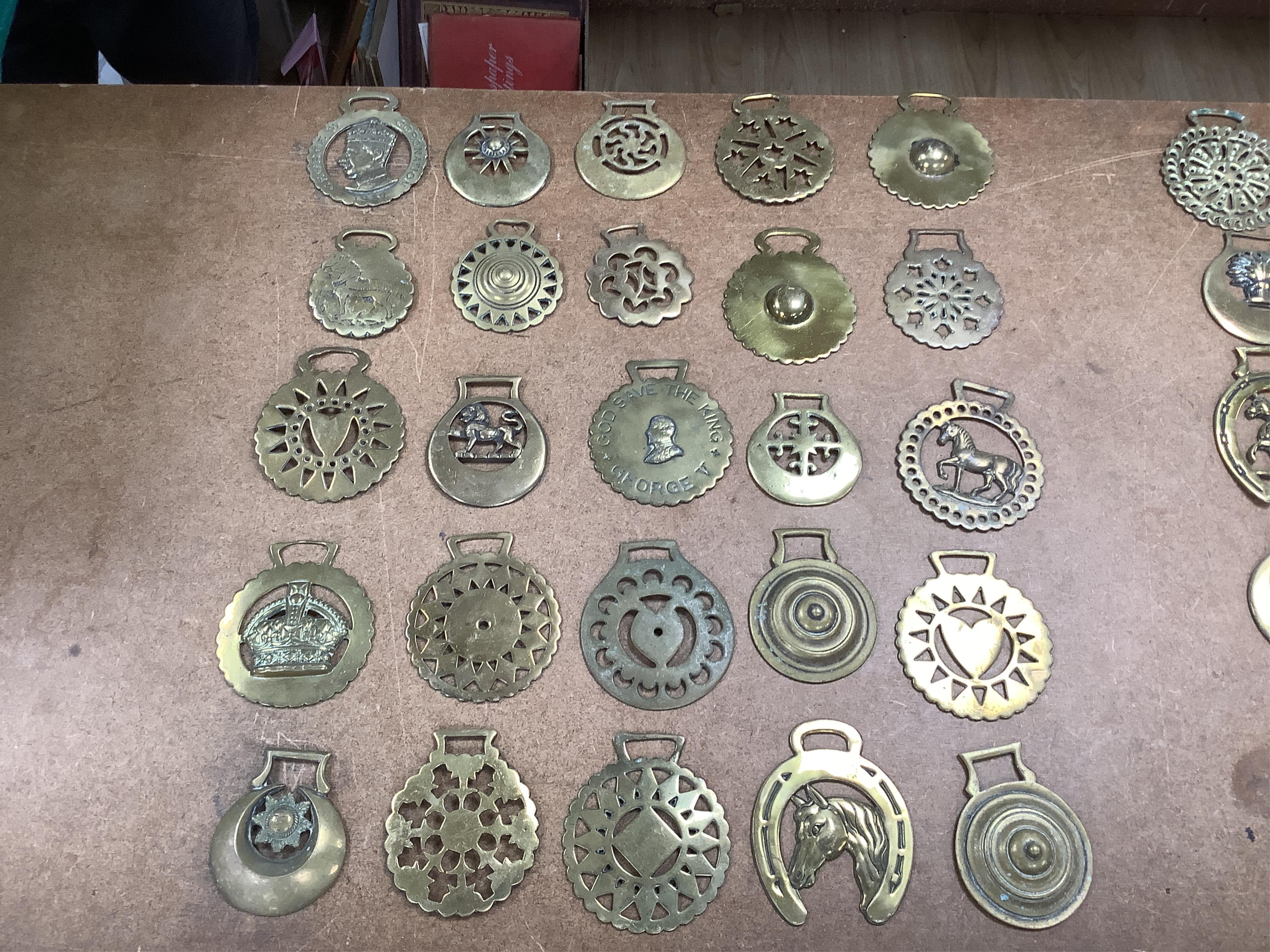 A collection of various horse brasses